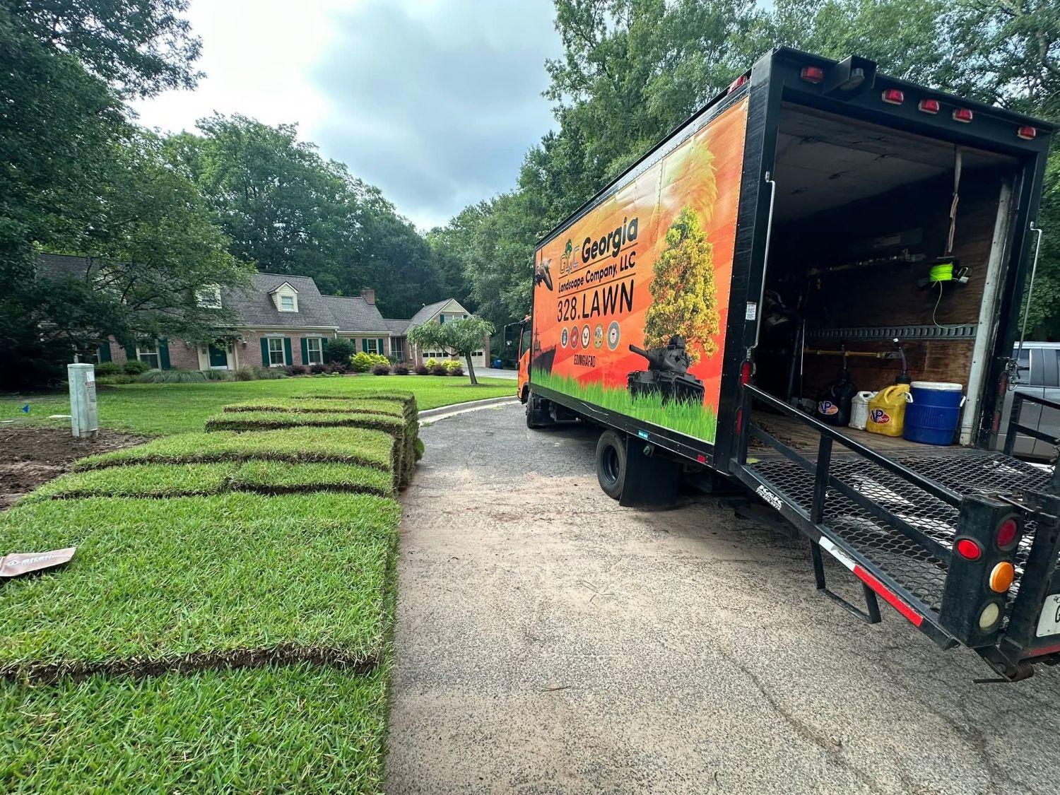 Sod: the orange GLC box truck in the cul-de-sac with pallets of fresh sod