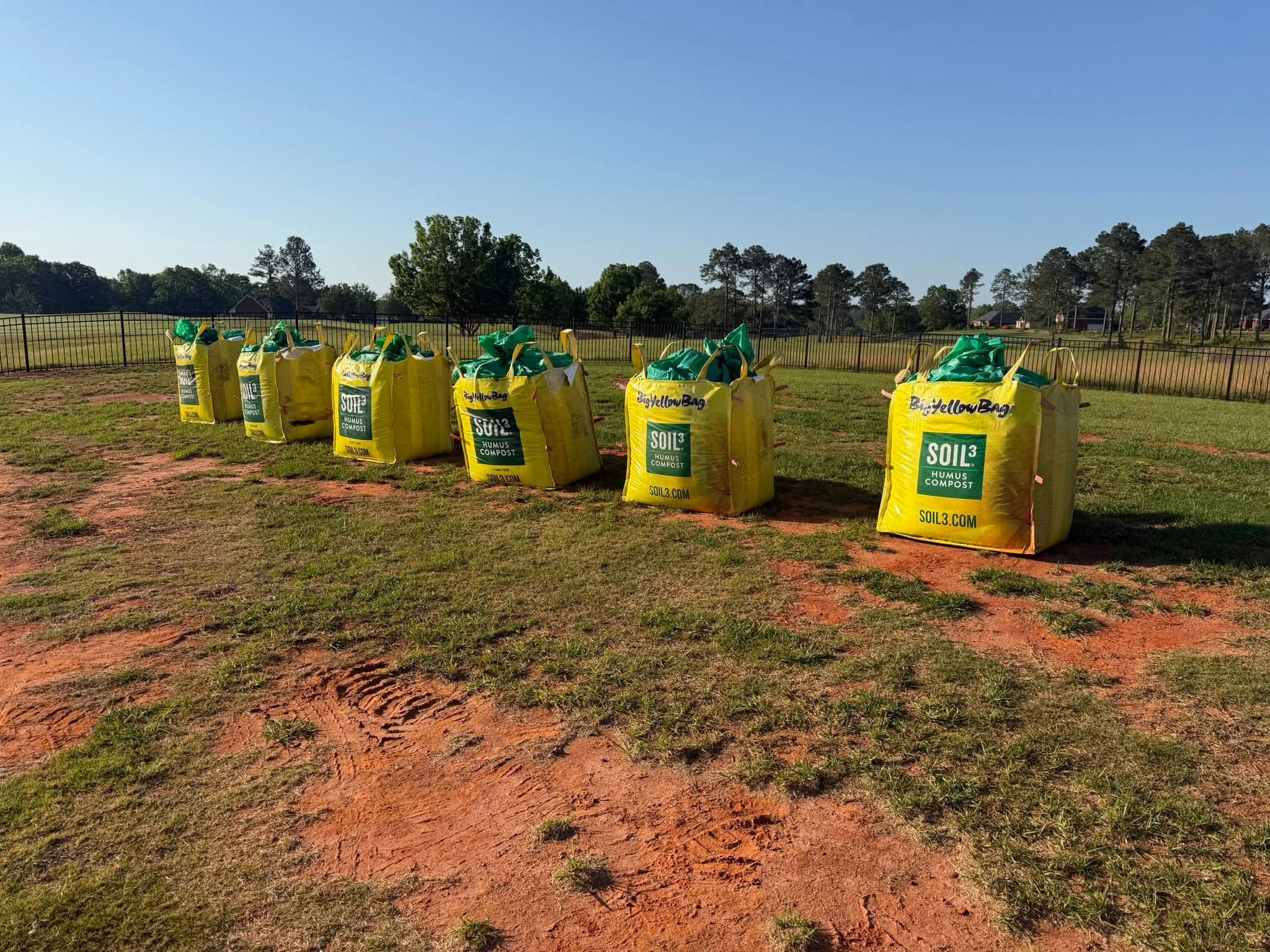 Bulk bags of Soil3 humus compost lined up on the job