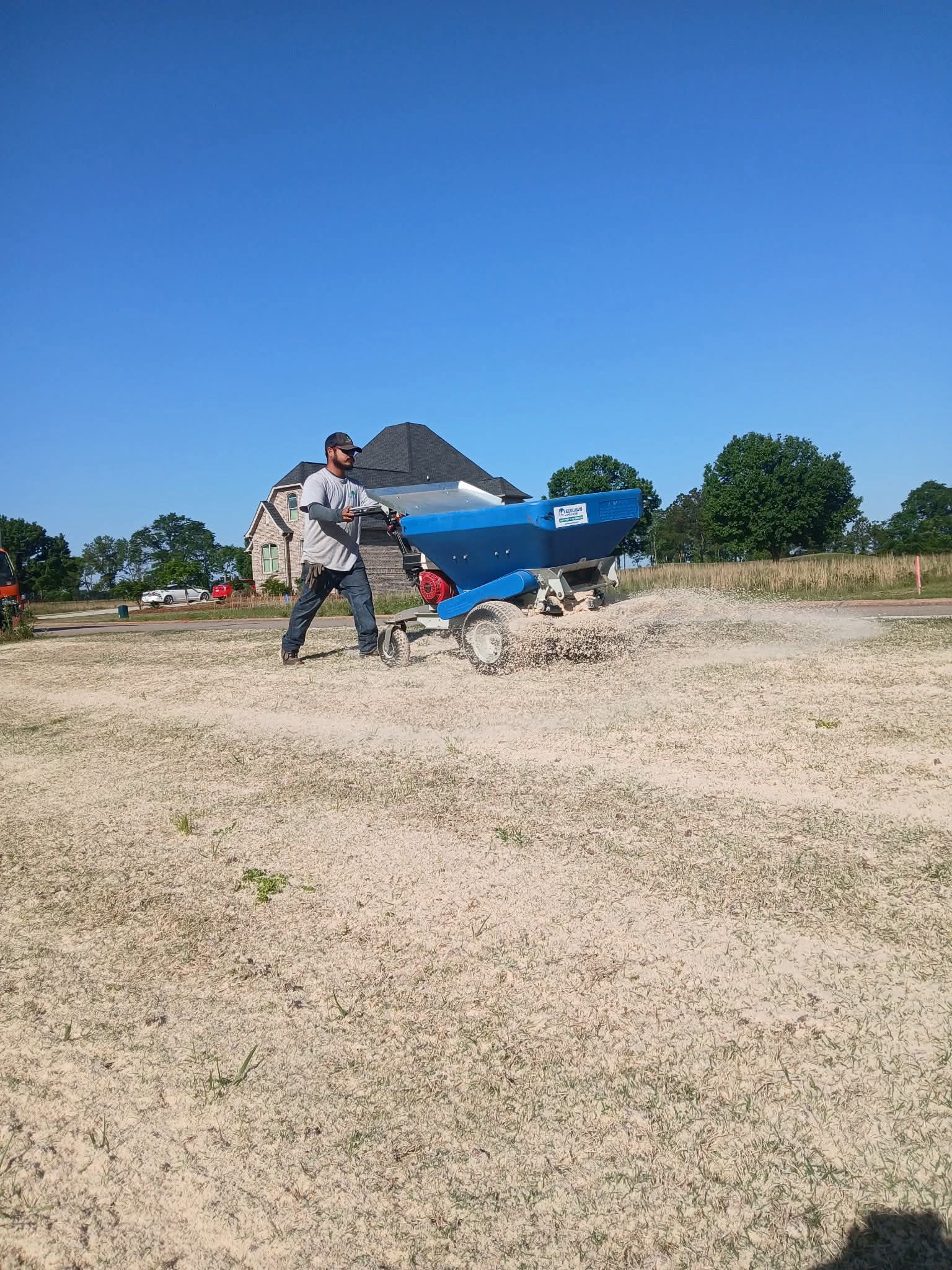 Spreading compost with the Ecolawn topdresser